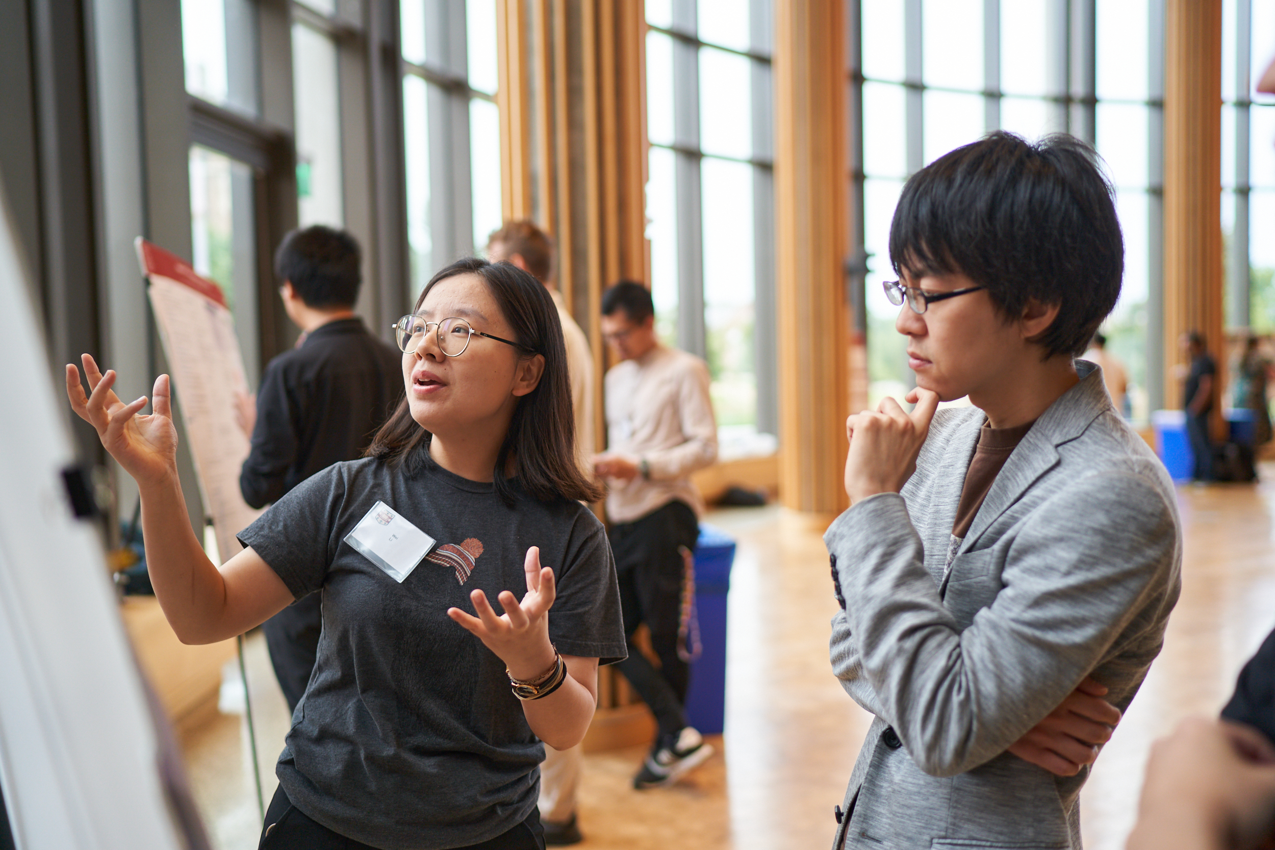 Two people speaking at a scientific poster