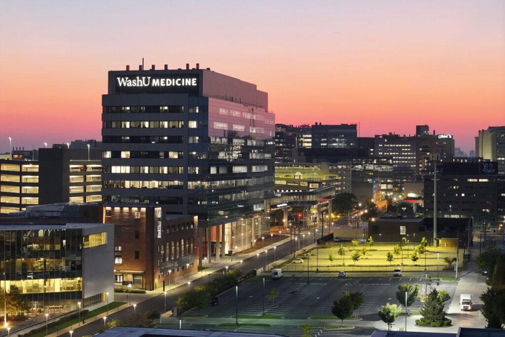 The Jeffrey T. Fort Neuroscience Research Building at twilight with downtown St. Louis in the background.