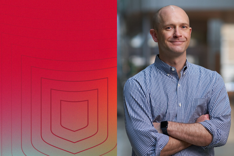 Harrison Gabel is a man wearing a blue shirt with his arms crossed.