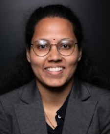 Ram Dyuthi Sristi has short dark hair and is wearing glasses.