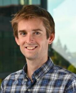 Frederick Arnold is a man with short hair and wearing a blue plaid shirt.